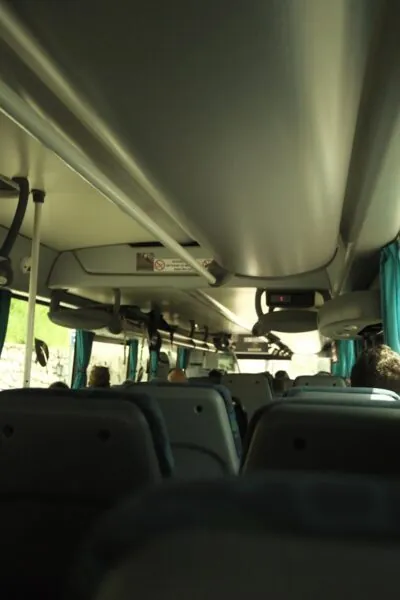 Inside of a bus, looking towards the front.